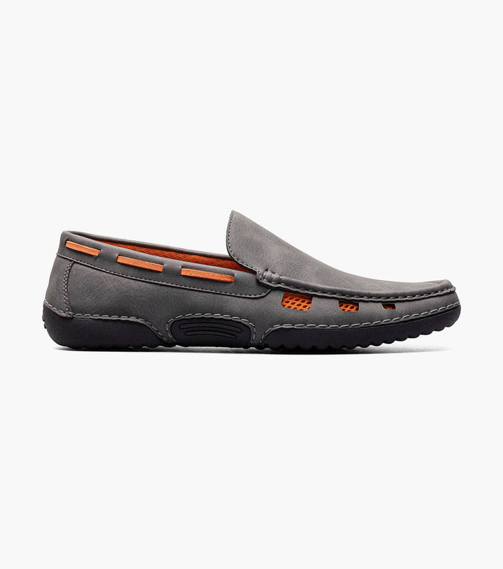 The Stacy Adams Grey Delray Moc Toe Slip On Shoes by Stacy Adams is a comfortable and stylish summer loafer, featuring a sleek grey design with vibrant orange detailing.