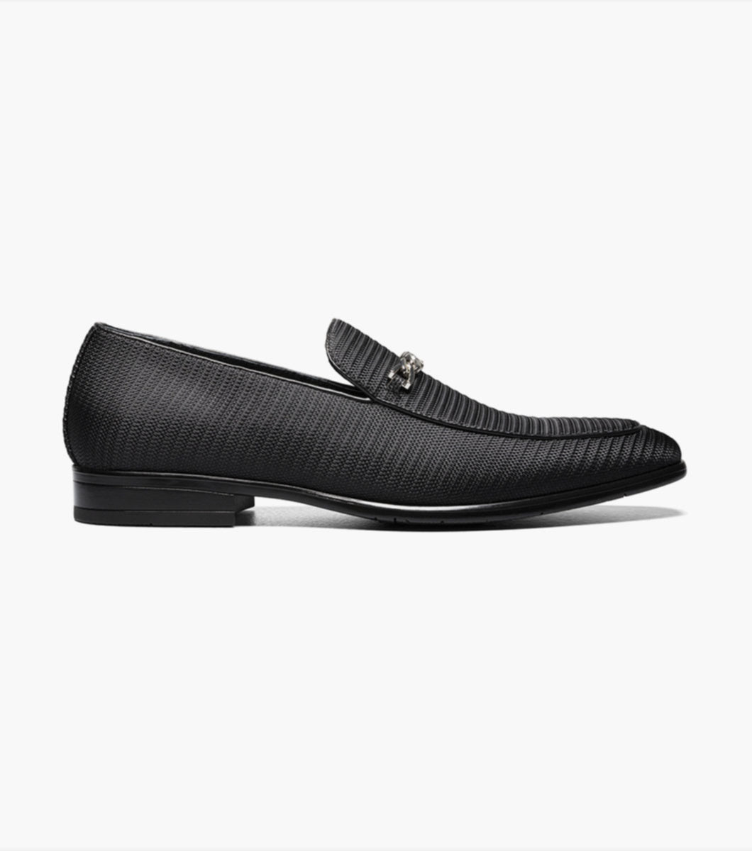 An elegant Stacy Adams Black Tazio Moc Toe Bit Slip-on Shoes adorned with a stylish metal buckle.
