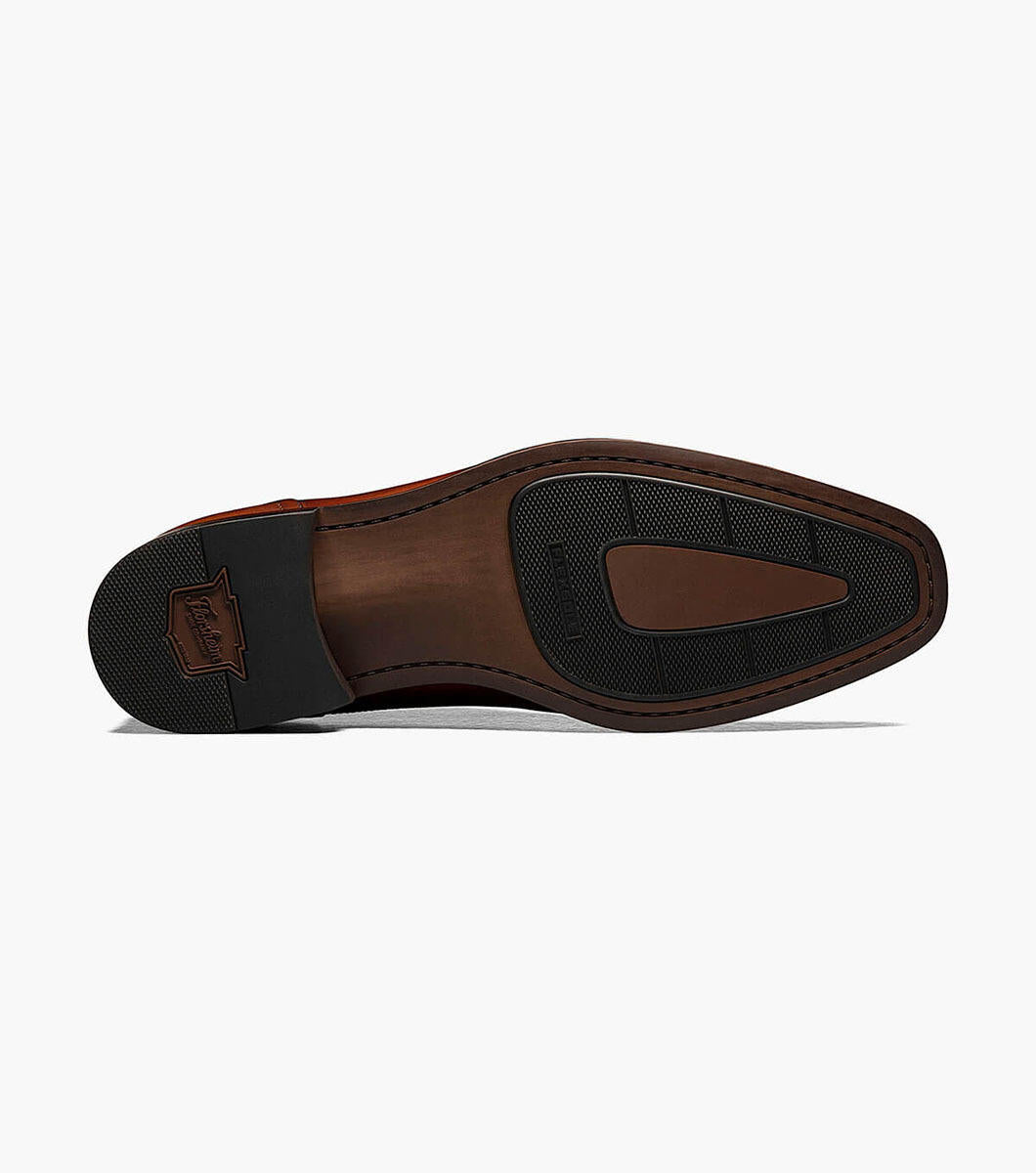 A Florsheim Cognac Plain Toe Single Monk Strap Shoe with a leather upper and rubber sole.