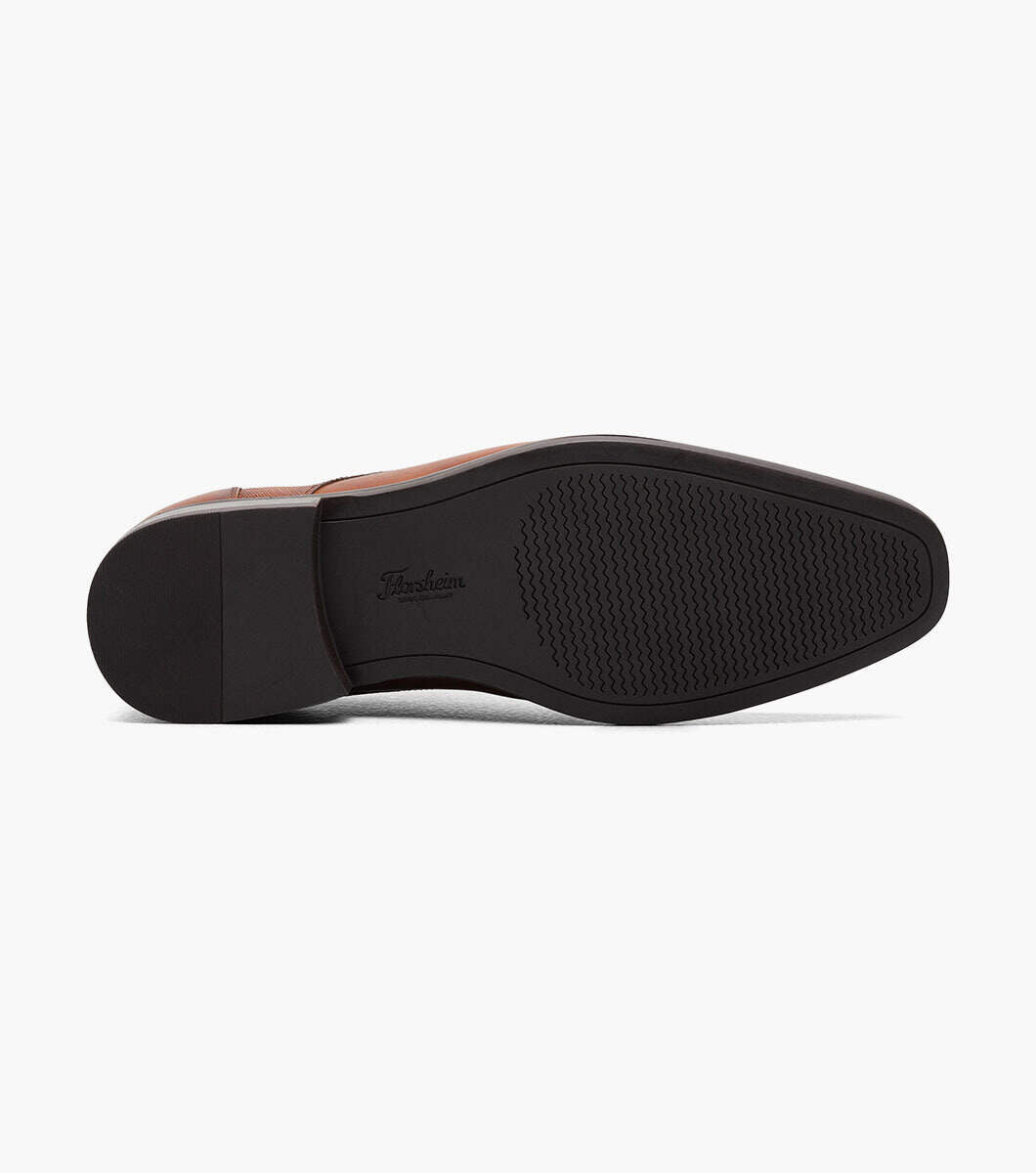 A pair of Florsheim Plain Toe Oxford Cognac shoes with black soles on a white background.