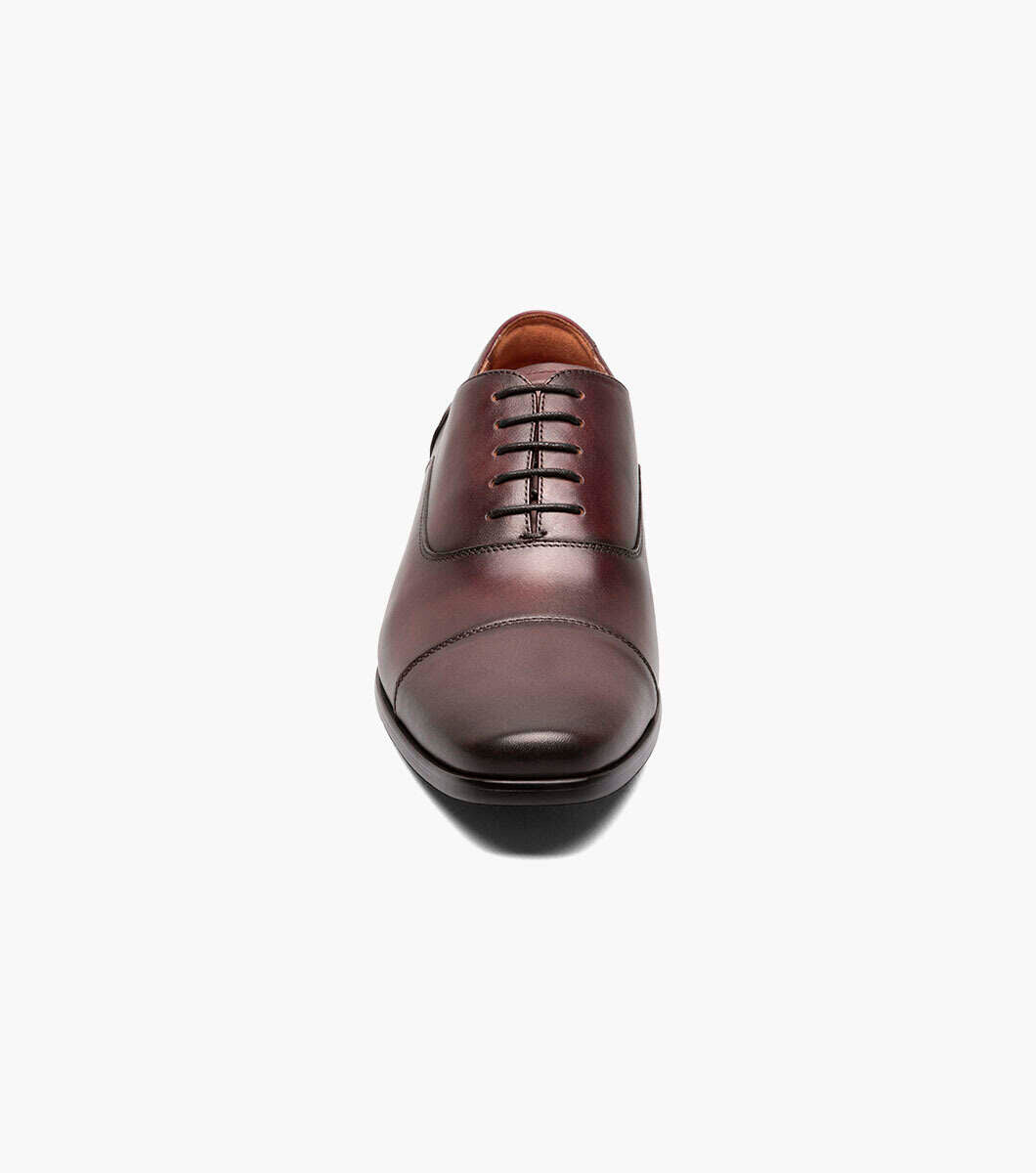 The Florsheim Wine Cap Toe Oxford Shoe by Florsheim exudes all-day comfort on a white background.