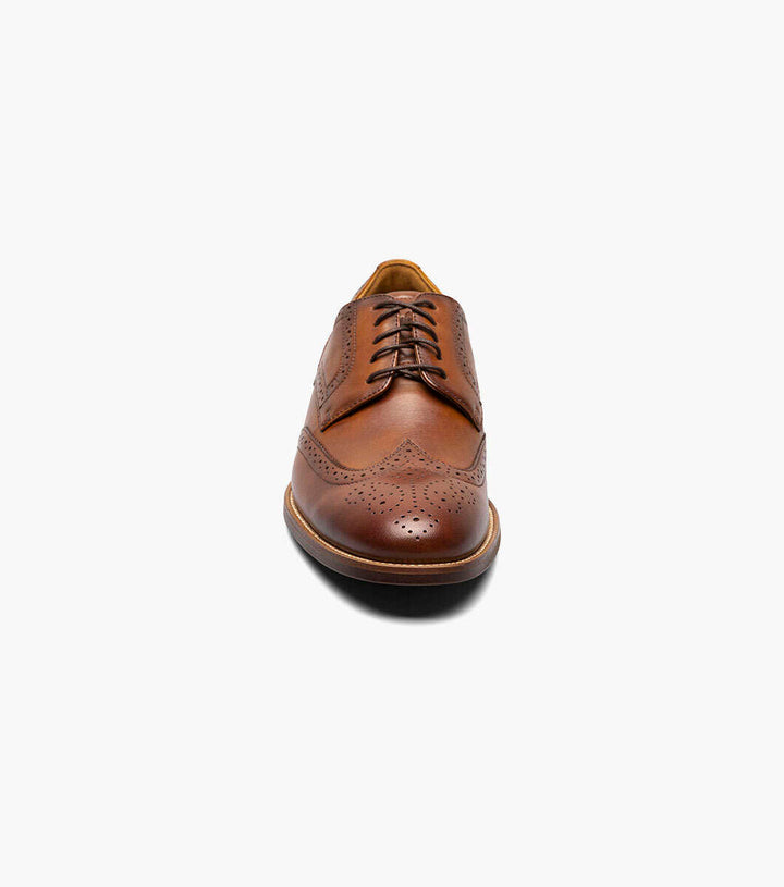 A Florsheim Cognac Wingtip Oxford Shoe on a white background.