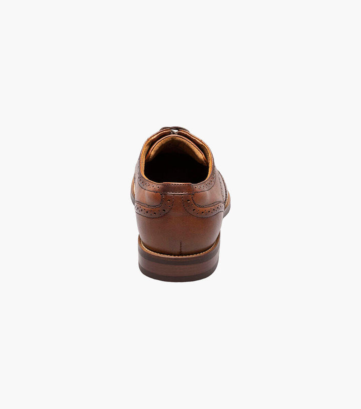 A Florsheim Cognac Wingtip Oxford Shoe for men, made from genuine leather, photographed on a white background.