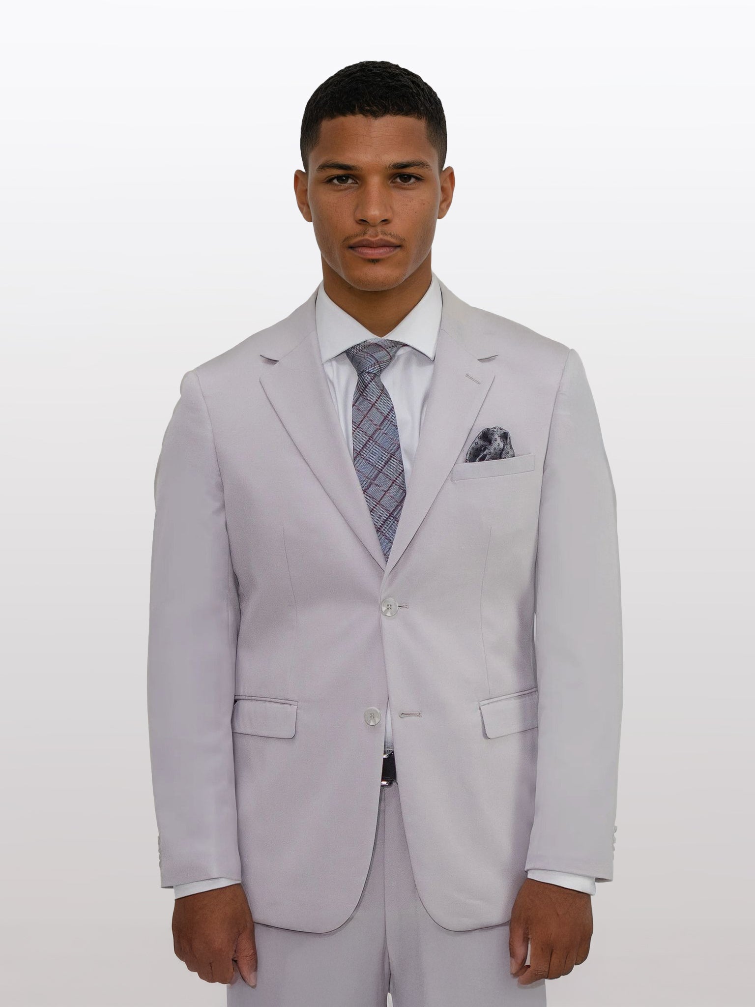 A man in a slim fit suit by Gianco Ferro stands facing forward, wearing the Men's Light Beige Solid Slim Fit Suit paired with a white shirt and patterned tie against a plain background.