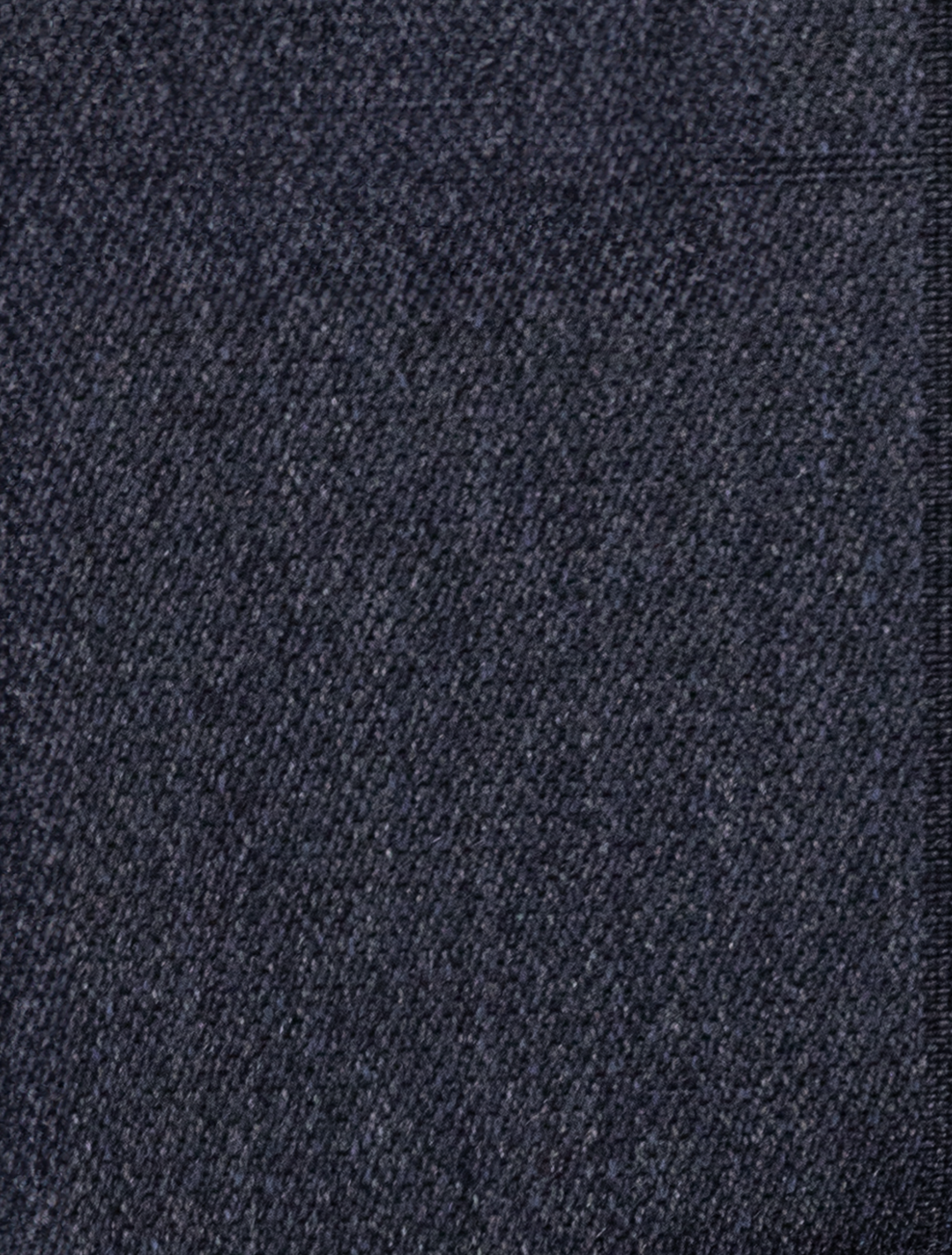 Close-up of dark blue denim fabric highlighting a diagonal weave pattern, similar to the refined texture in the FUBU Polo Blue Peak Lapel 2-Piece Suit by Fubu The Colle.