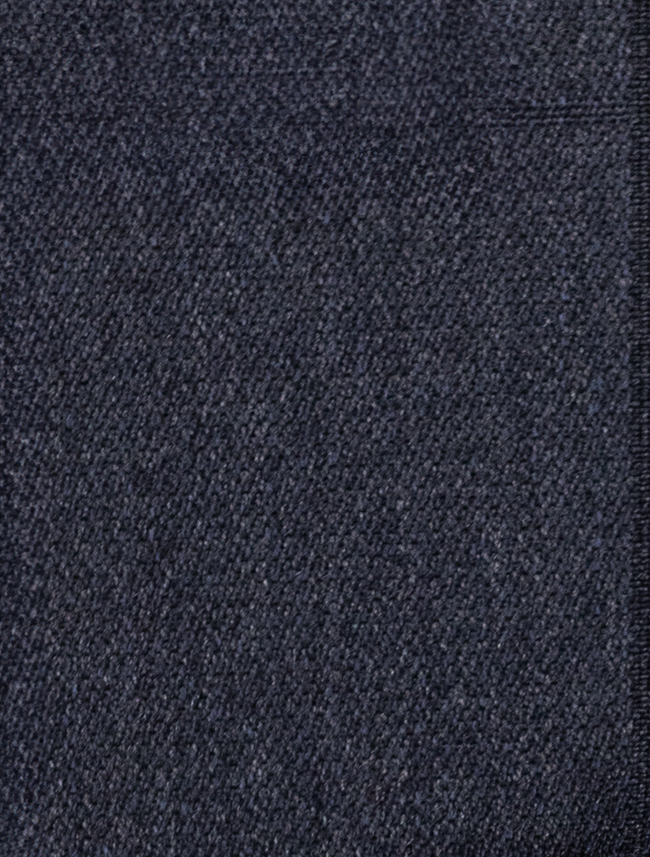 Close-up of dark blue denim fabric highlighting a diagonal weave pattern, similar to the refined texture in the FUBU Polo Blue Peak Lapel 2-Piece Suit by Fubu The Colle.