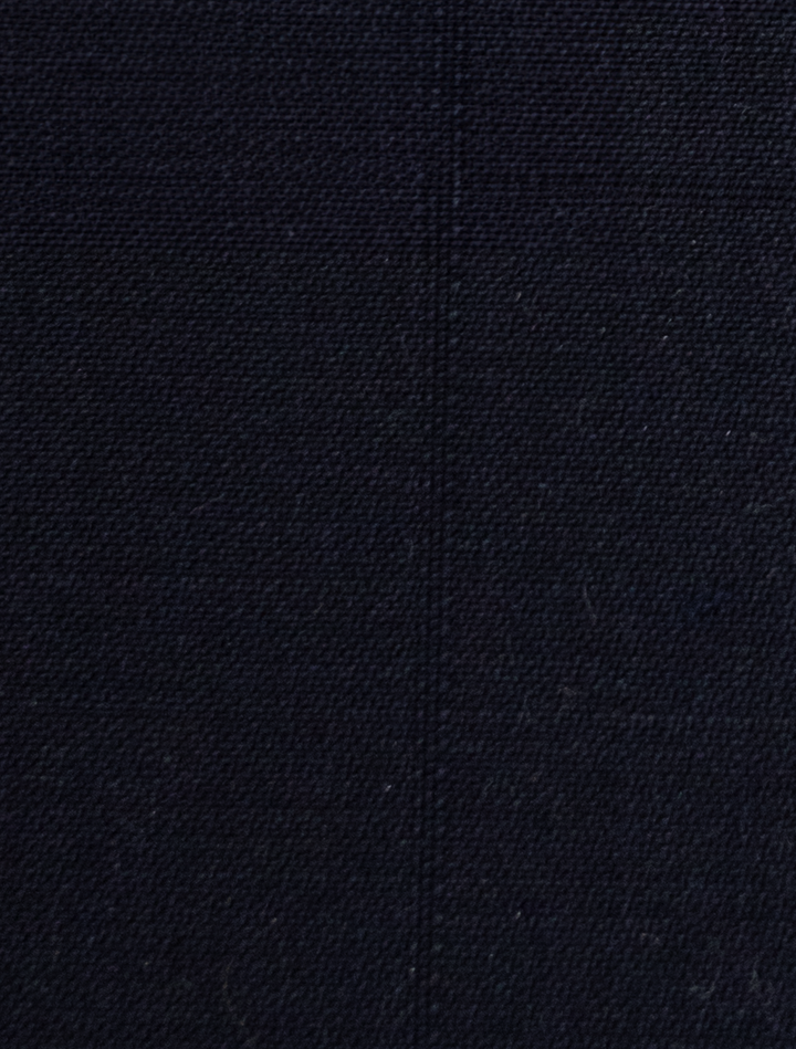 A close-up of the FUBU Midnight Navy Vested Suit by Fubu The Colle showcases a coarse, woven texture and a visible vertical seam, perfect for a modern fit.