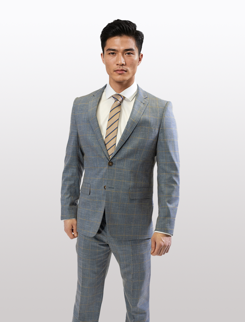 Wearing a FUBU Steel Blue with Mustard Windowpane 2-Piece Suit, a man stands confidently against a white backdrop, highlighting its slim fit and stretch armhole for comfort.