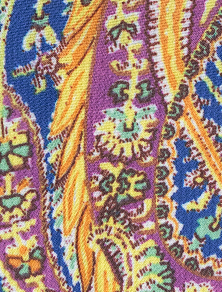 Close-up of a colorful fabric pattern featuring intricate paisley designs in purple, yellow, blue, and green, ideal for a modern fit garment like the FUBU Steel Blue with Mustard Windowpane 2-Piece Suit from Fubu The Colle.