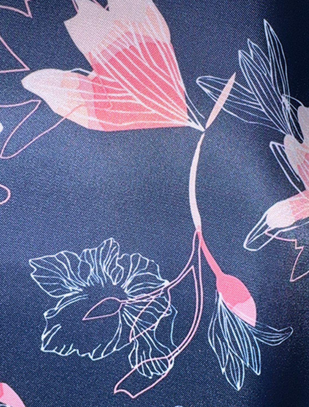 A close-up of the FUBU Rose with Cherry Windowpane Sport Jacket by Fubu The Colle displays a floral fabric pattern featuring pink and white flowers with leaves on a dark blue background, exuding the detailed elegance typical of tailored sport coats.