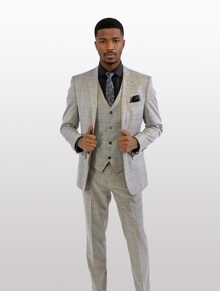 A man in a FUBU Light Grey with Charcoal Windowpane Vested Suit by Fubu The Colle, paired with a black shirt, gives two thumbs up.