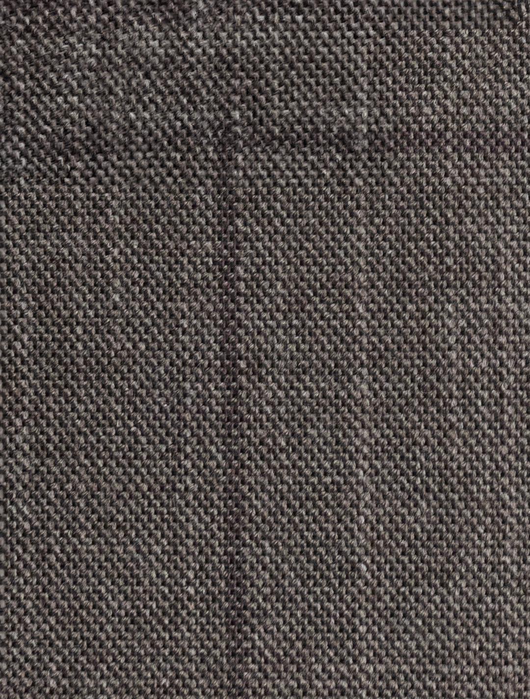 Close-up of the FUBU Taupe with Brown Windowpane Vested Suit textile by Fubu The Colle, featuring a dark gray, coarse woven texture ideal for crafting a slim fit suit.