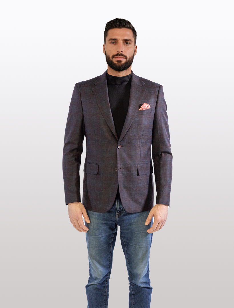 A man stands in a FUBU Midnight Navy with Wine Windowpane Sport Jacket by Fubu The Colle, paired with a black turtleneck and jeans, highlighted by a pink pocket square.