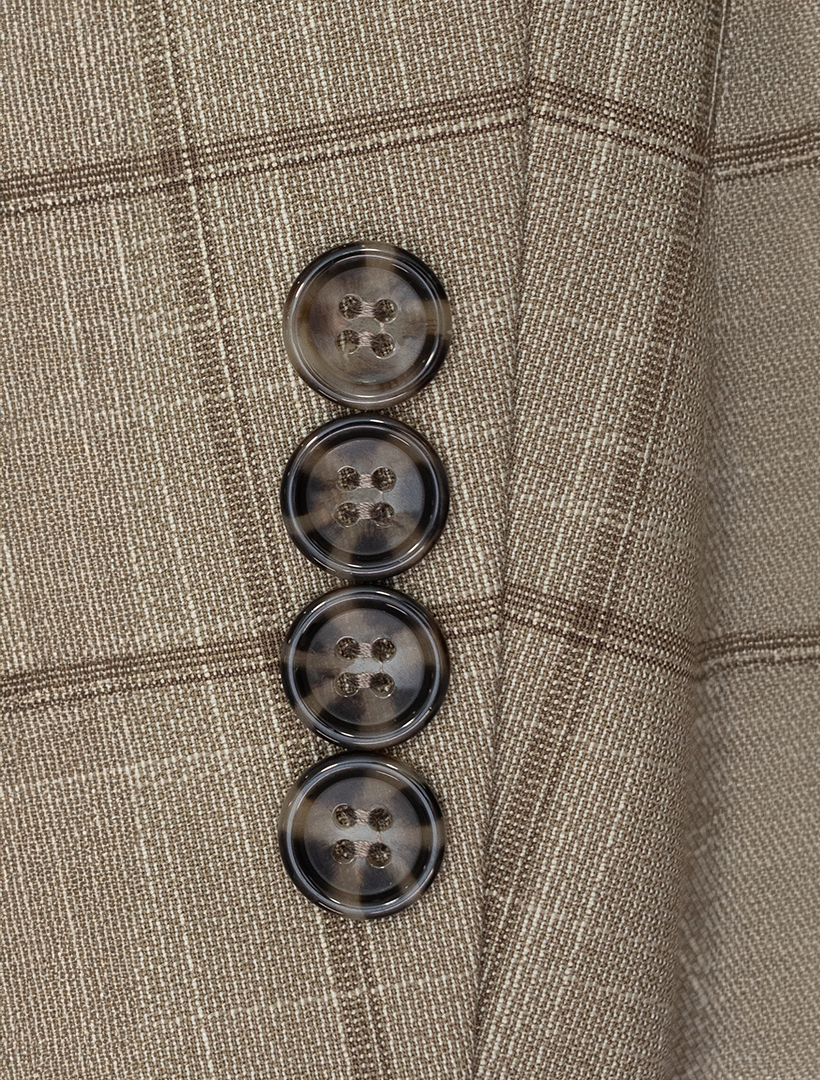 Close-up of a sleeve on the FUBU Camel with Mocha Windowpane 2-Piece Suit by Fubu The Colle, featuring four dark, round buttons in a vertical line, combining classic style with a modern fit.