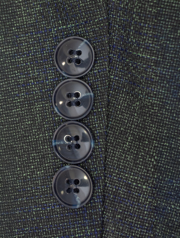 Close-up of four dark buttons on the sleeve of a FUBU Deep Olive with Navy Windowpane Sport Jacket, showcasing the timeless elegance typical of Fubu The Colle.