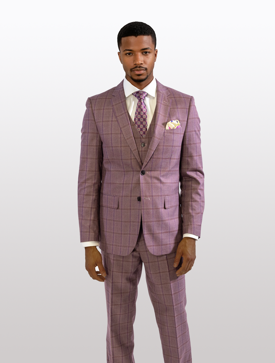 A man in a FUBU Mauve Taupe with Purple Windowpane Vested Suit by Fubu The Colle stands confidently against a plain background.