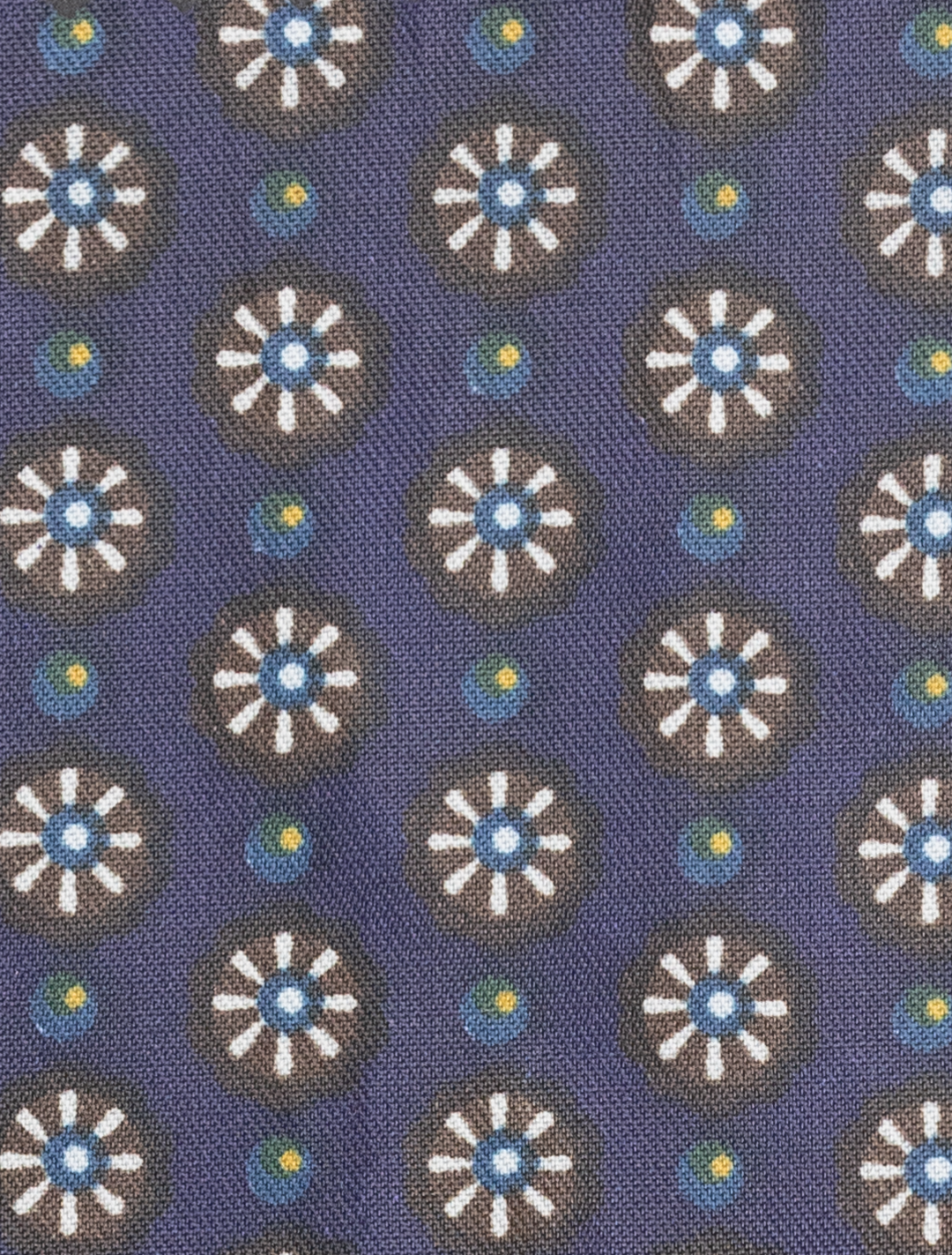 Modern fit fabric featuring white and blue floral motifs with yellow dots on a dark blue background, designed for a sleek silhouette in the FUBU Mauve Taupe with Purple Windowpane Vested Suit by Fubu The Colle.