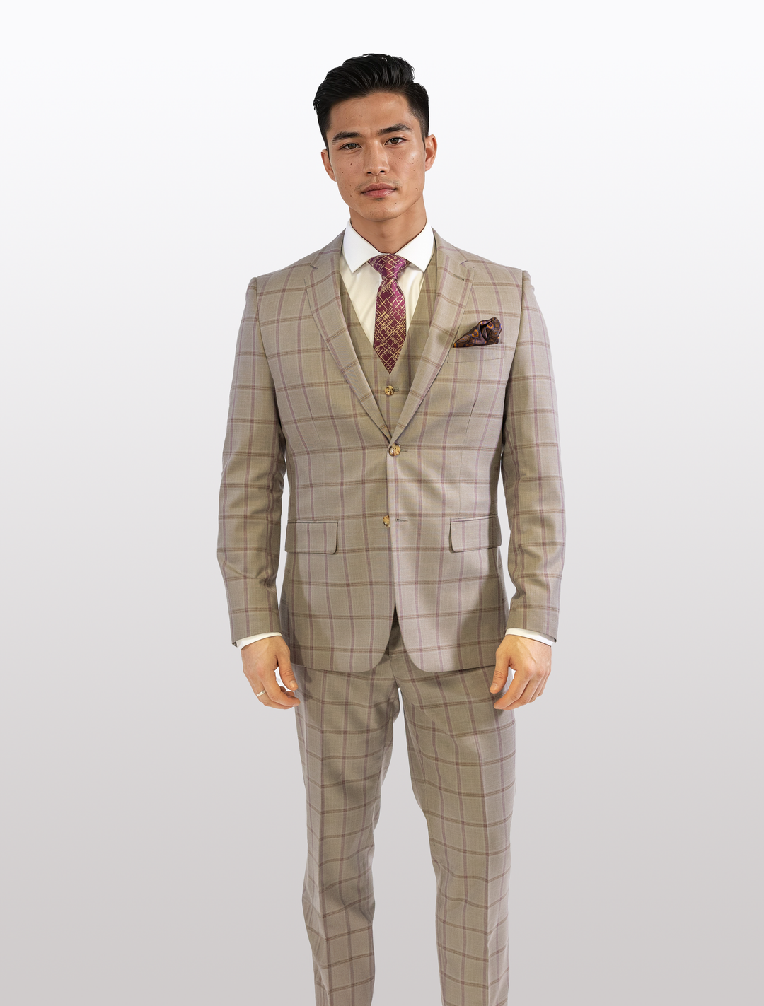 Wearing a FUBU Tan with Maroon Windowpane Vested Suit by Fubu The Colle, a person stands confidently against a plain background, paired with a crisp white shirt and patterned tie.
