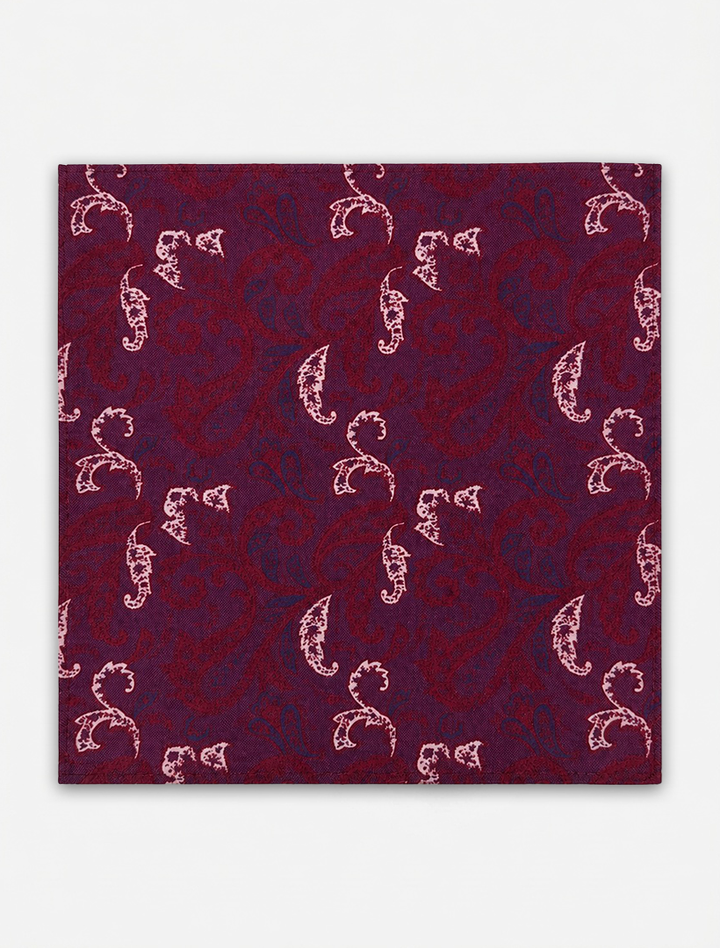 The Karako Collecti Burgundy Floral Pocket Square Handkerchief features a square fabric swatch with a maroon background and a light pink paisley pattern, displayed on a white surface. Made from elegant microfiber, this pocket square is wrinkle resistant, making it an ideal accessory for formal occasions.