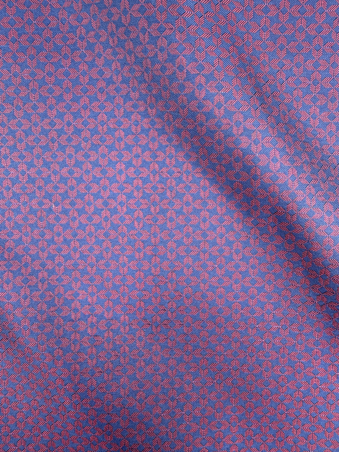 Close-up of the Navy with Burgundy Arrow Pocket Square Handkerchief by Karako Collecti, showcasing a geometric arrow pattern in navy and burgundy hues. The fine microfiber material is slightly folded, casting subtle shadows across the design. Ideal for elevating your formal look or adding a touch of sophistication to any suit as a men&