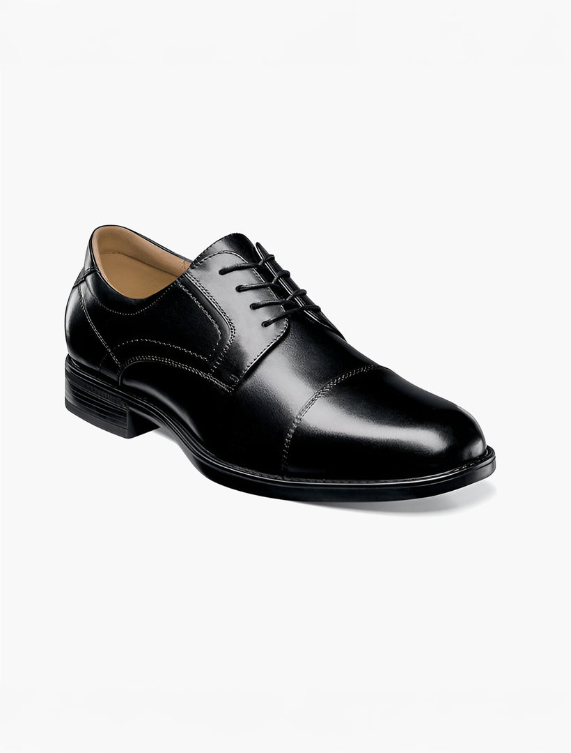 The Florsheim Black Cap Toe Midtown Men's Shoes feature a leather upper, lace-up closure, low heel, cap toe, and Ortholite high rebound foam for comfort. Shown here on a plain white background.