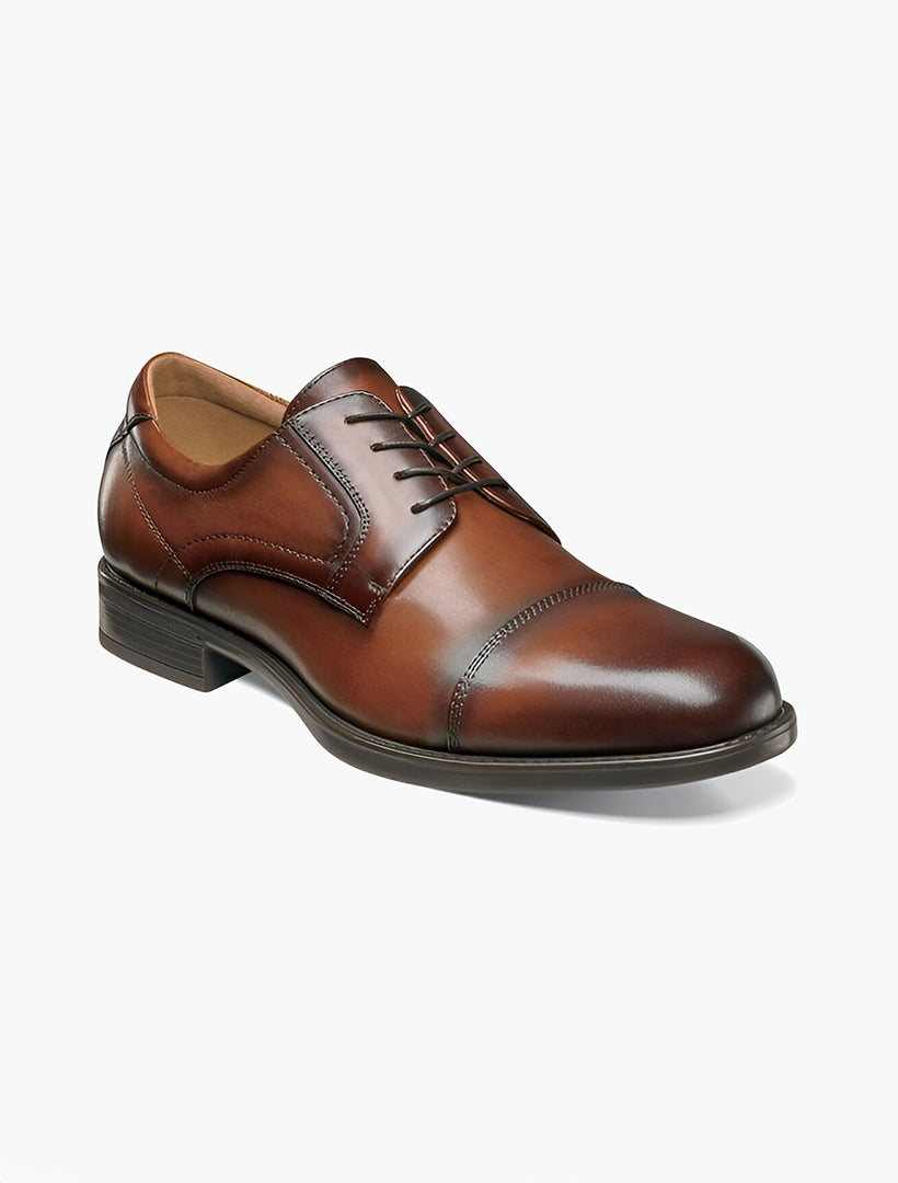 Florsheim Cognac Cap Toe Midtown Men's Shoes feature a lace-up closure, low heel, and Comfort technology with Ortholite high rebound foam, displayed on a white background.