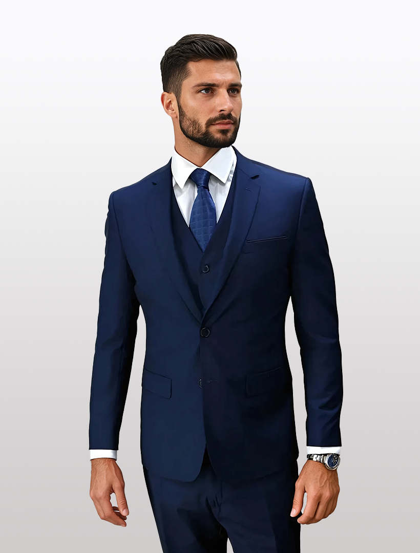 A man in a Statement Men's Sapphire 100% Wool Slim Fit Suit, paired with a crisp white shirt and a blue tie, stands against a plain background.