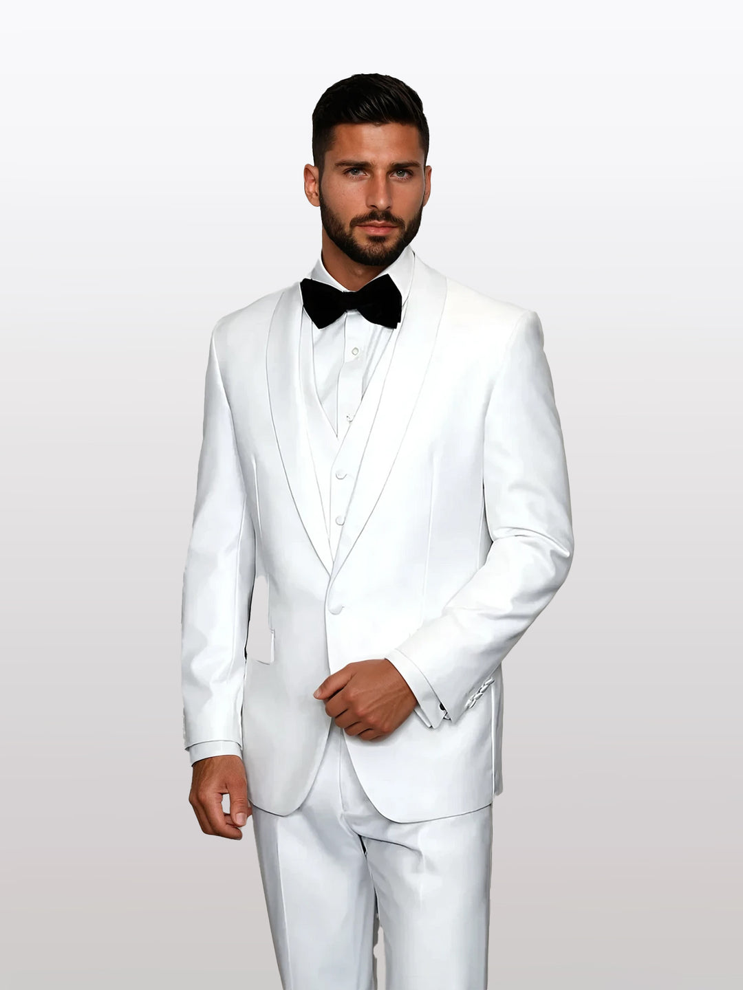 A person wearing the Statement Men's White with White Lapel Vested 100% Wool Tuxedo stands gracefully against a plain background. The white suit, complemented by a black bow tie, exudes timeless elegance.