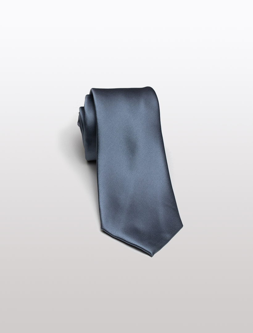 A rolled Medium Grey Men's Microfiber Tie from Karako Collecti rests elegantly on a light gray background, perfectly complementing the sophisticated appeal of Karako Suits.