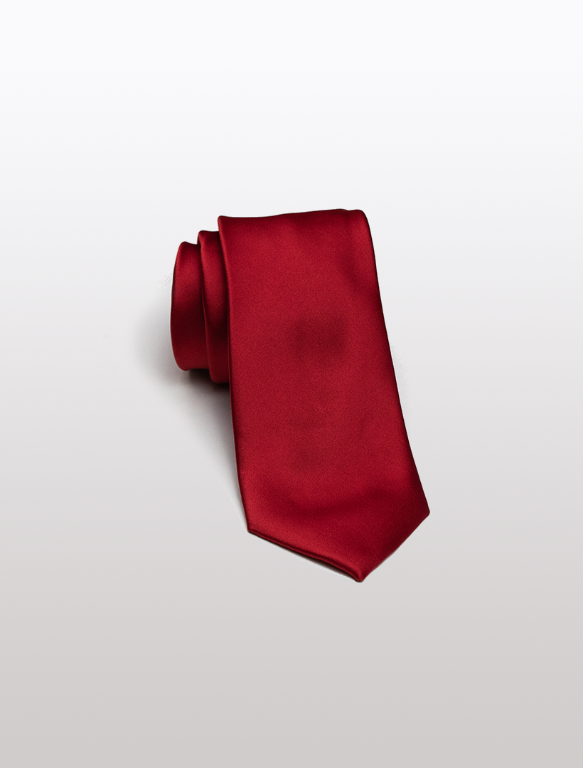 A neatly rolled red men's microfiber tie from Karako Collecti, perfect for complementing their suits, rests elegantly on a plain white background.