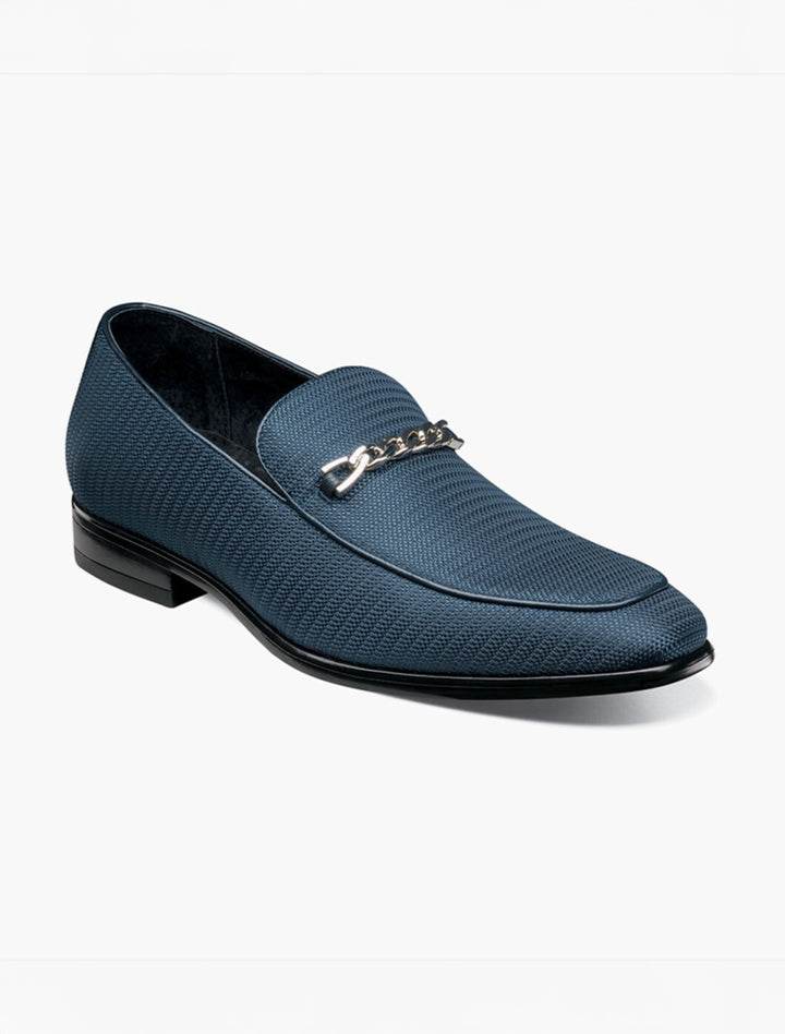 The Stacy Adams Navy Tazio Moc Toe Bit Slip-on Shoe features a blue knit fabric upper, gunmetal bit detail, and is shown on a white background.