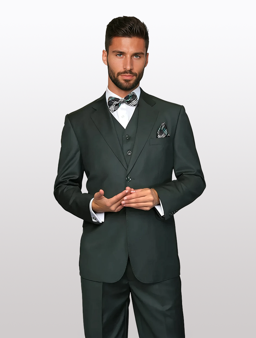 A man stands against a plain background, gesturing with hands and looking at the camera, wearing the Statement Men's Solid Hunter Green 100% Wool Vested Suit in a modern fit.