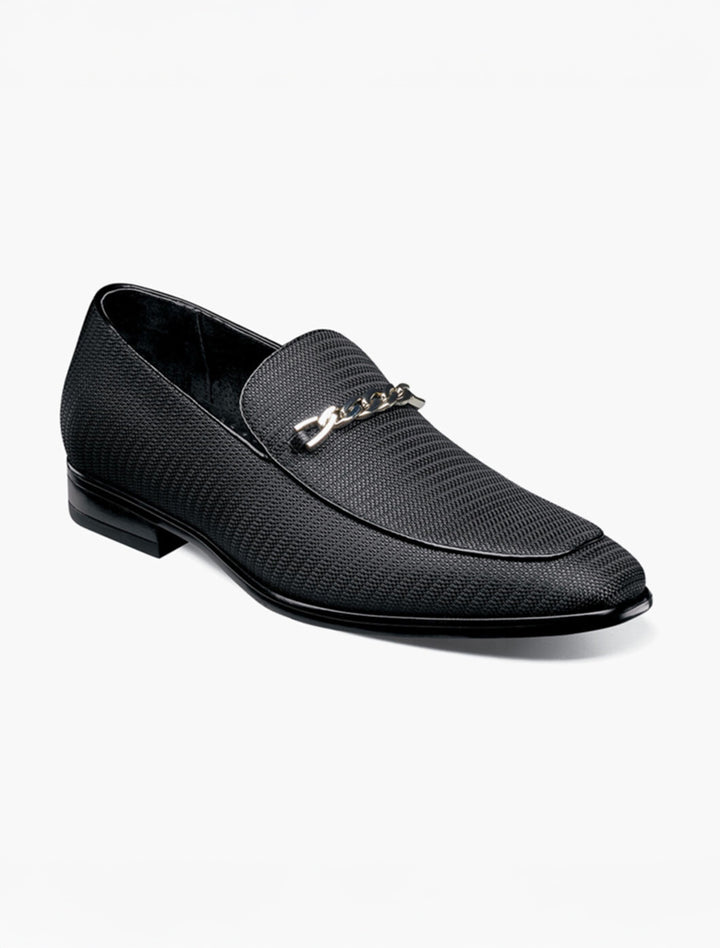 The Stacy Adams Black Tazio Moc Toe Bit Slip-on Shoes feature textured leather, a low heel, and a stylish gunmetal bit across the upper, shown here on a white background.