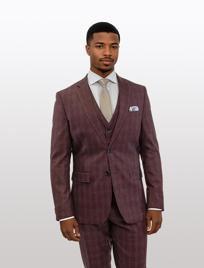 A man in a sharp FUBU Burgundy Tartan Vested Suit by Fubu The Colle stands against a plain background. His white dress shirt and patterned tie complement the stretch armhole design, crafted from Tetron Rayon for comfort and sophistication.
