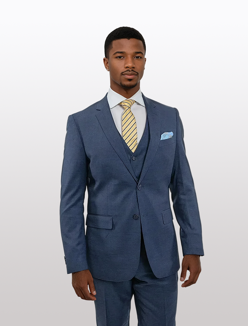 A man in a FUBU Blue Windowpane Vested Suit by Fubu The Colle stands against a plain white background, featuring a slim fit jacket with notch lapels and stretch armholes, paired with a light blue shirt and yellow striped tie.