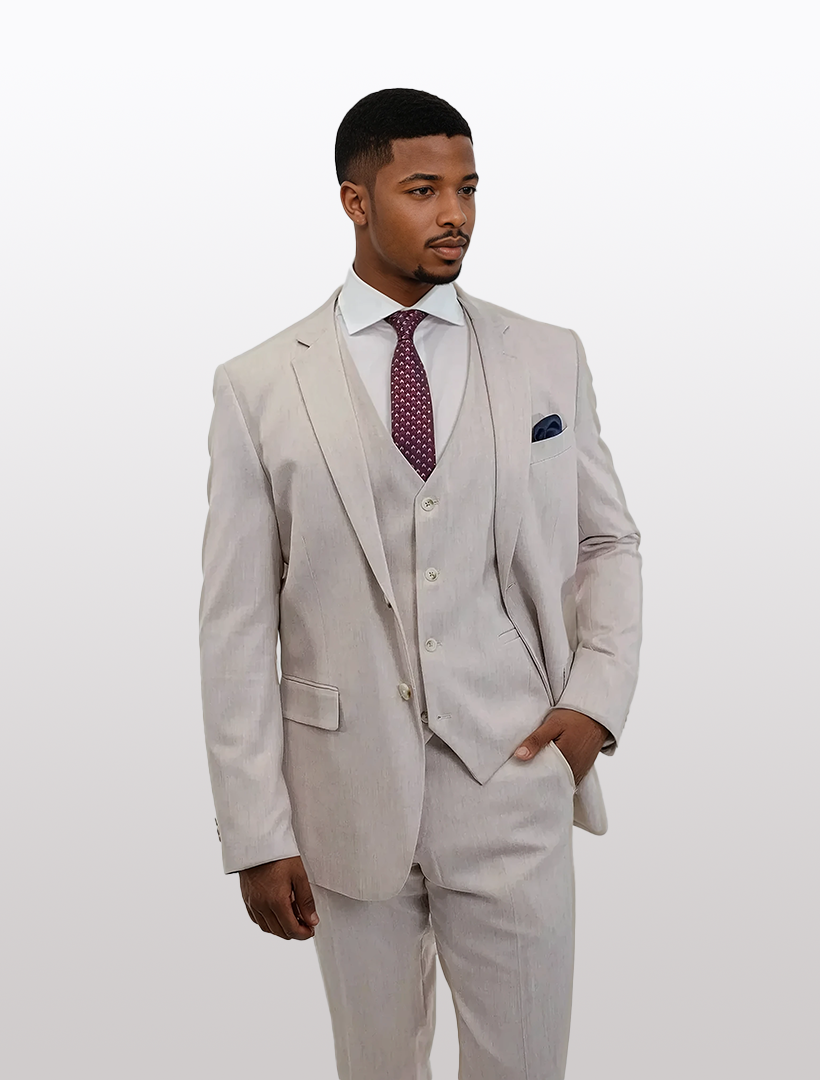 Man in a FUBU Salmon Crosshatch Vested Suit by Fubu The Colle, featuring a slim fit and stretch armhole for comfort, paired with a maroon tie and pocket square against a plain backdrop.