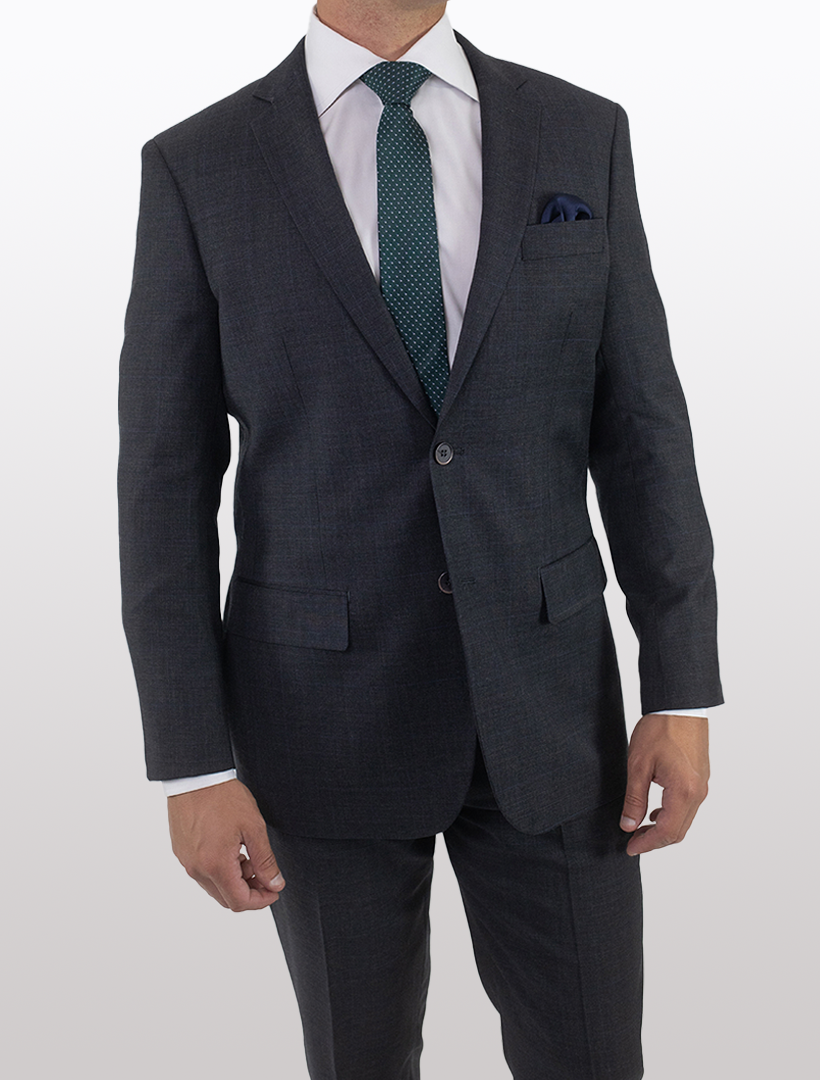 A person wearing a Men's Charcoal with Navy Windowpane Slim Fit Wool Suit from Karako & Sons, paired with a white shirt and teal tie, stands against a plain background.