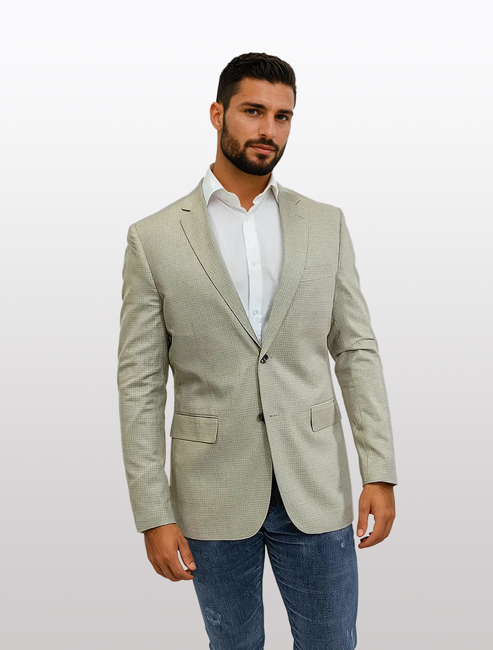 A person poses stylishly against a plain background in the FUBU Slim Fit Beige Graph Check Sport Jacket by Fubu The Colle.