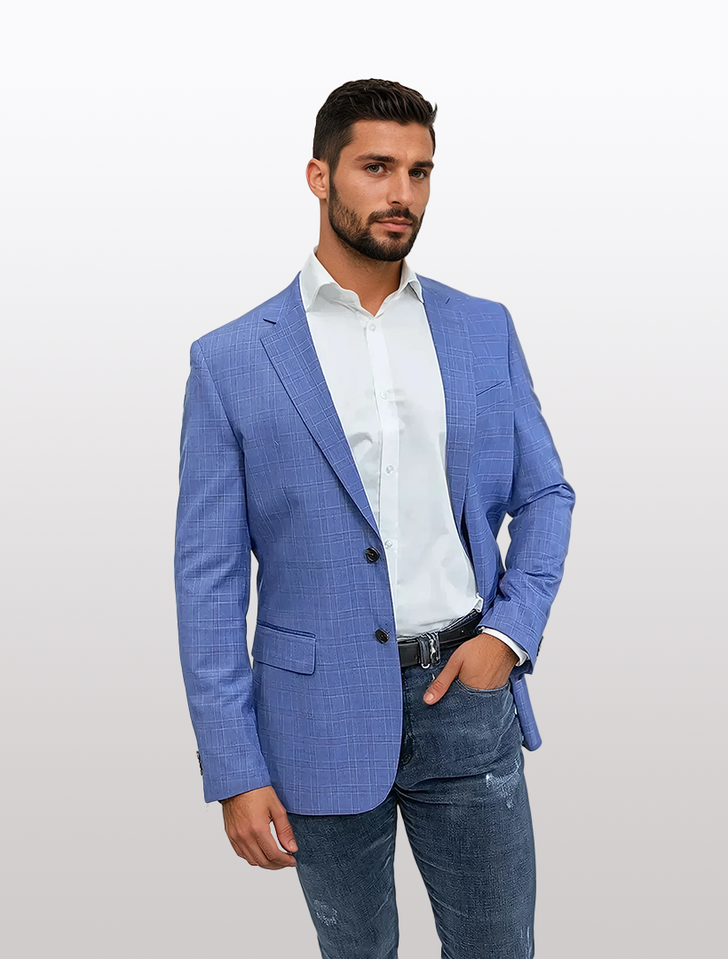A man wearing a FUBU Slim Fit Light Blue Tartan Sport Jacket by Fubu The Colle, paired with a white shirt and jeans, stands against a plain background.