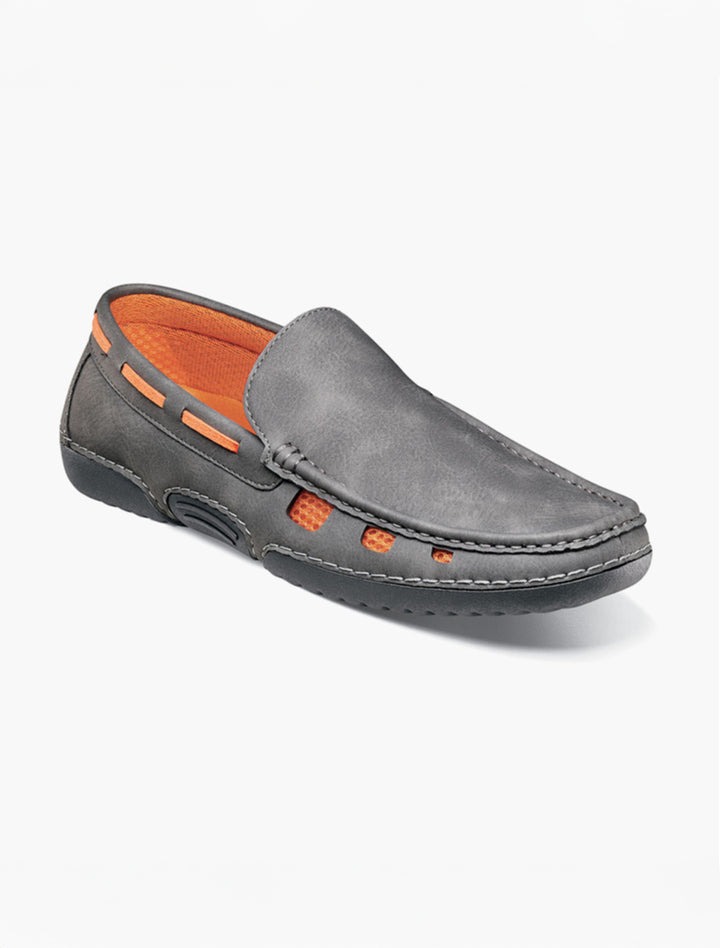 The Stacy Adams Grey Delray Moc Toe Slip On Shoes feature orange lining, visible stitching, cut-out sides, and a cushioned insole—offering breezy summer style and comfort on a plain white background.