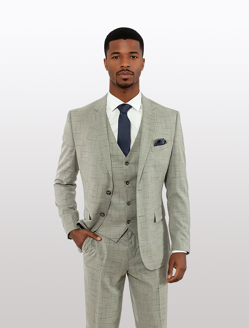 A man in a FUBU Light Grey with Navy Fading Windowpane Vested Suit by Fubu The Colle stands against a plain background, exuding understated elegance.