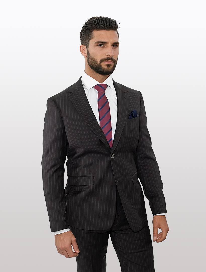 A man confidently poses in a Douglas Grahame Men's Brown Rope Stripe Wool Slim Fit Suit, complemented by a white shirt and striped tie, as if ready for an important interview. Standing against a plain white background, he embodies the ideal interview attire.