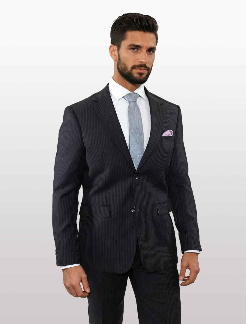 A man wearing a Douglas Grahame Men's Black Chalk Stripe Wool Slim Fit Suit, paired with a white shirt and light gray tie, stands against a plain background.