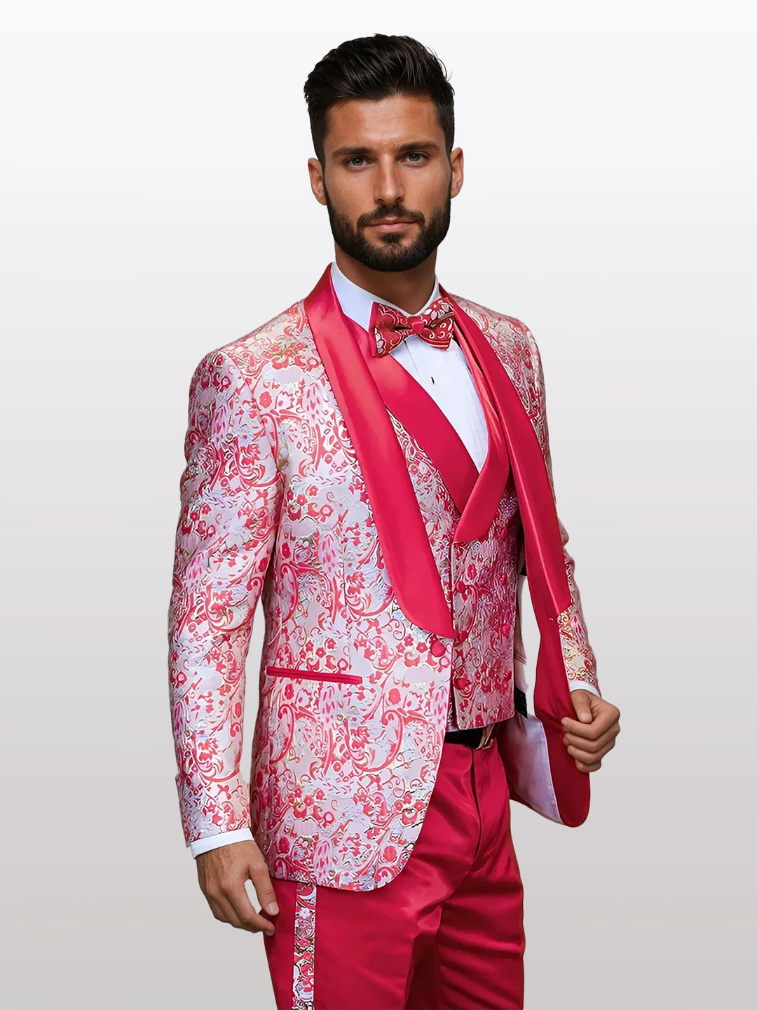 A man in a Statement Men's Off Coral Patterned Vested Tuxedo with Bowtie stands against a plain background.
