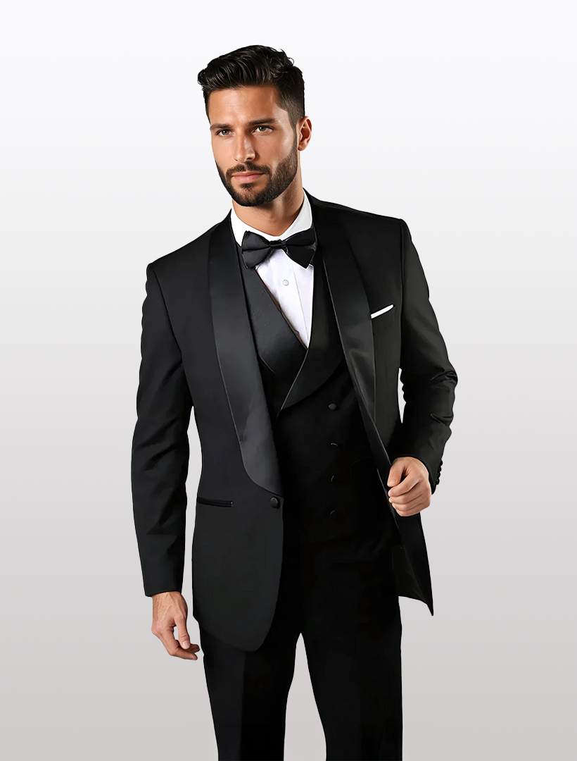 A man in a tailored fit black tuxedo, 100% wool, by Statement, featuring a bow tie and white shirt against a neutral background.