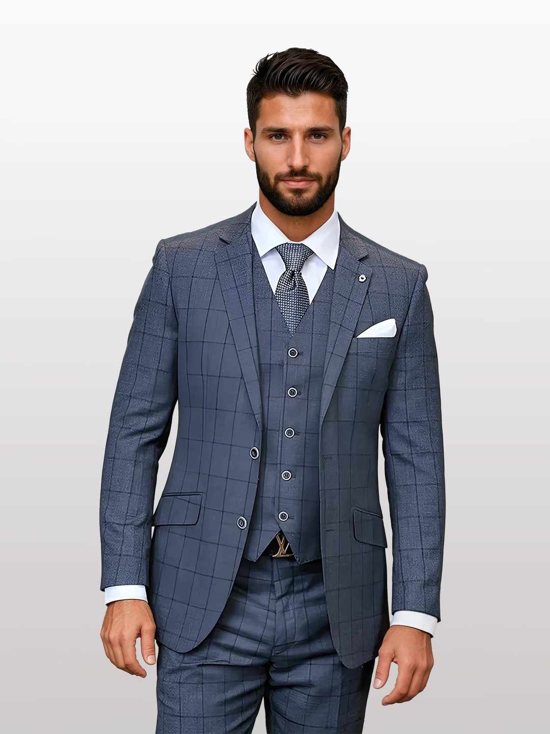 A man stands against a plain background wearing the Statement Men's Charcoal Windowpane Modern Fit Vested Suit, made entirely of wool, paired with a crisp white shirt and patterned tie.
