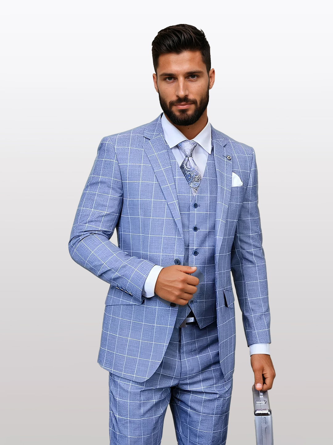 Man wearing a Statement Men's Steel Blue Windowpane Modern Fit Vested Suit made of 100% wool, holding a tie against a neutral background.