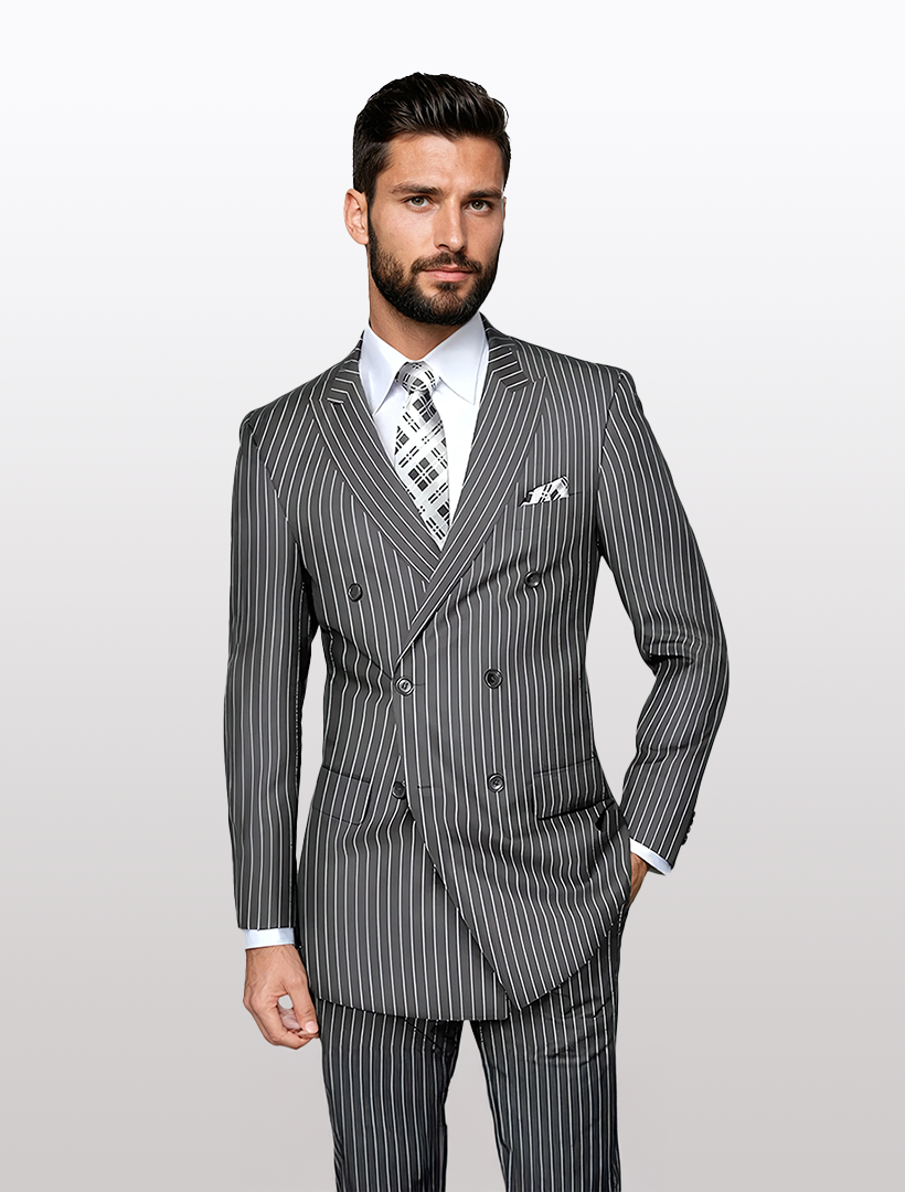Man in a Statement Men's Grey Pin Stripe Double Breasted Suit, featuring a white shirt and patterned tie, stands against a light gray background.