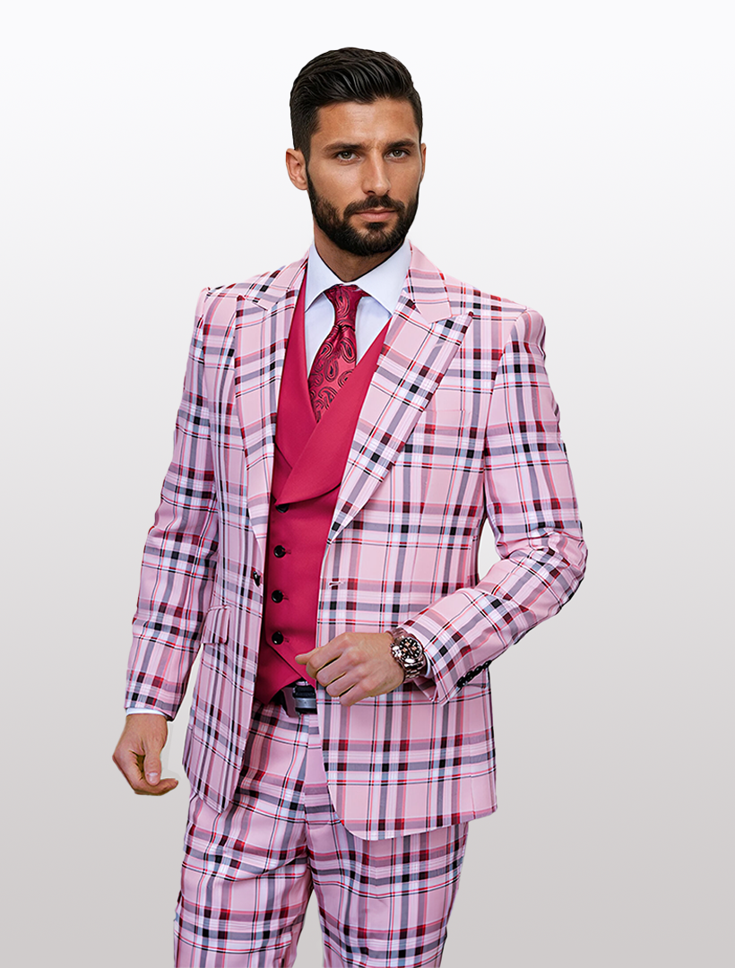 A man confidently poses in a Statement Men's Hunter Pink Tartan Patterned Vested Suit, complemented by a watch, red waistcoat, and tie. He holds the button on his 100% wool single-breast jacket against a white background.