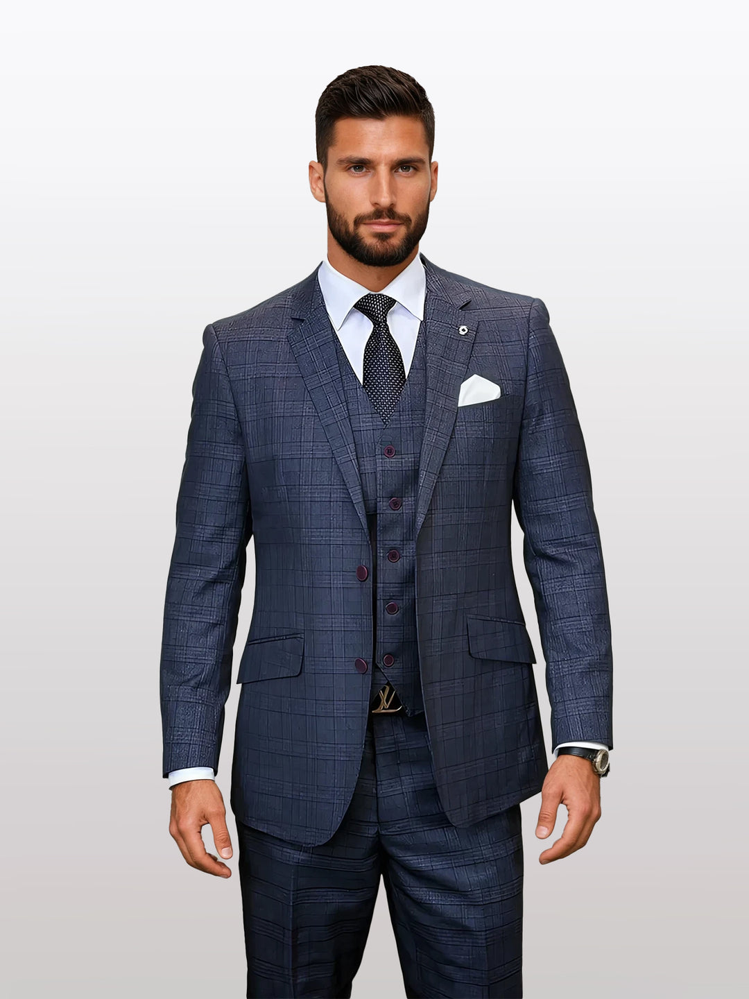 A man in a Statement Men's Charcoal Windowpane Plaid Modern Fit 100% Wool Vested Suit stands against a plain background, showcasing modern fit elegance with his white shirt, black tie, and pocket square.